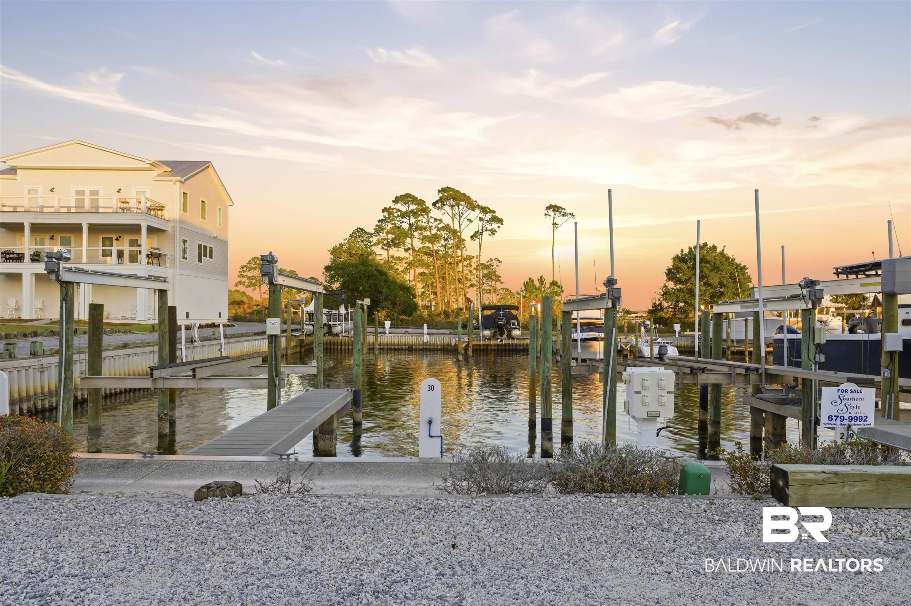 Image 3: Dock featuring a water view and boat lift