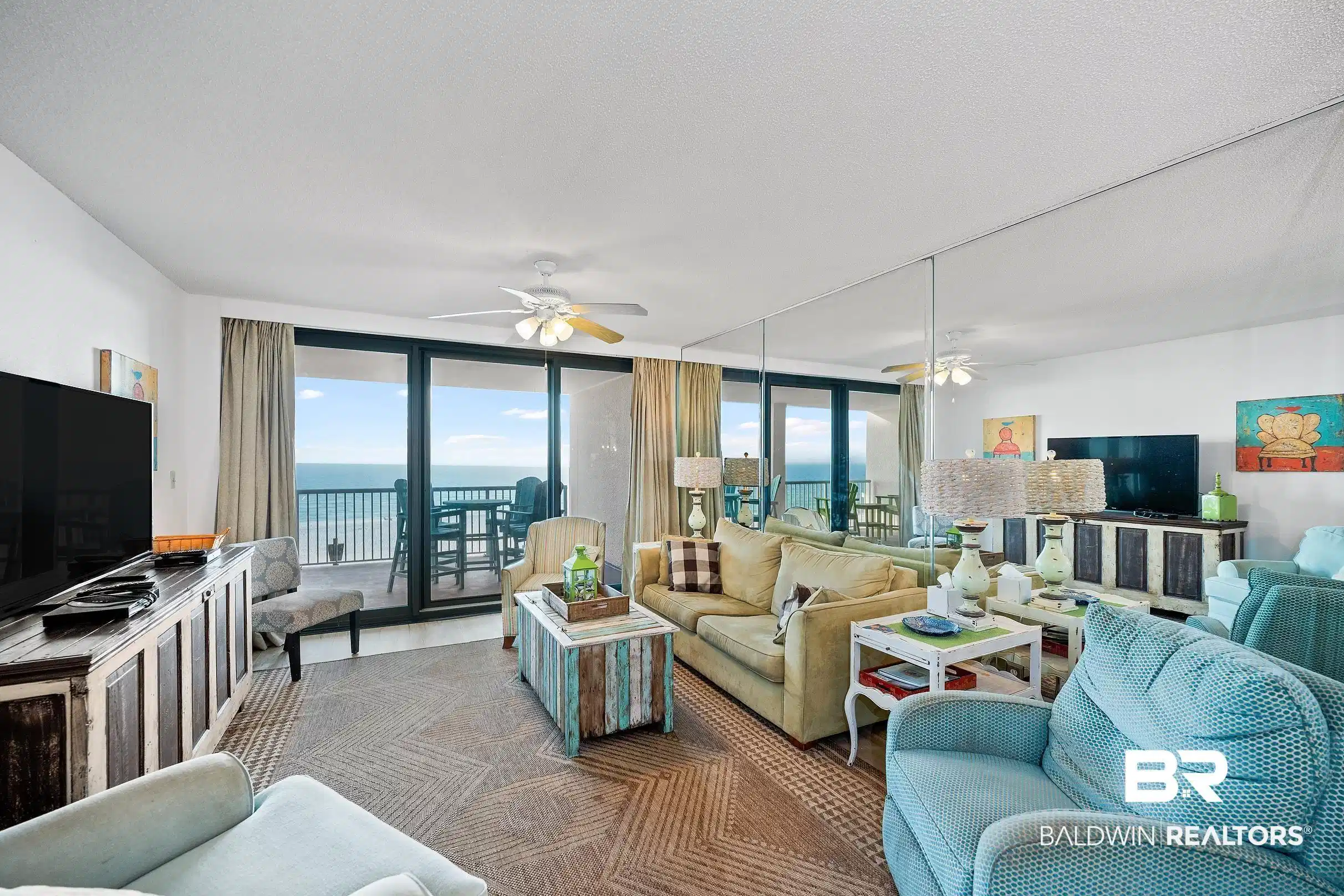 Image 1: Living room featuring a ceiling fan and a wall of windows