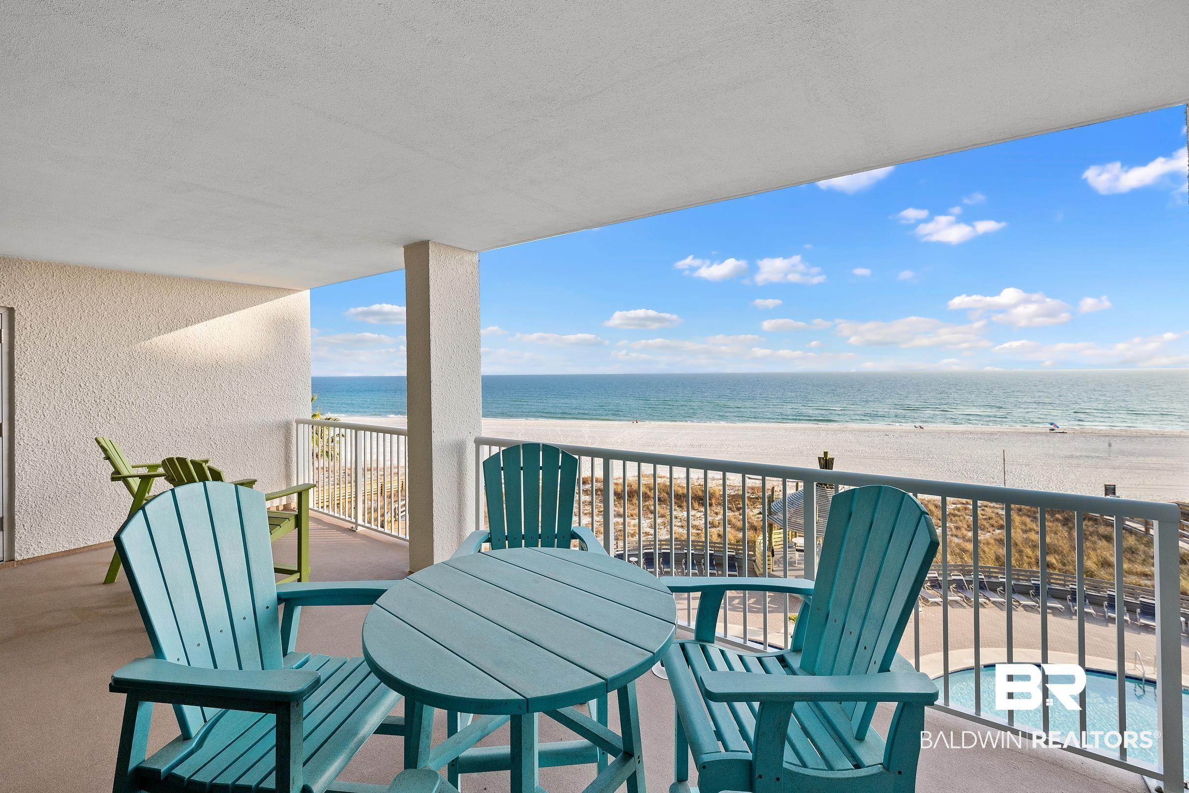 Image 2: Balcony featuring view of water and beach