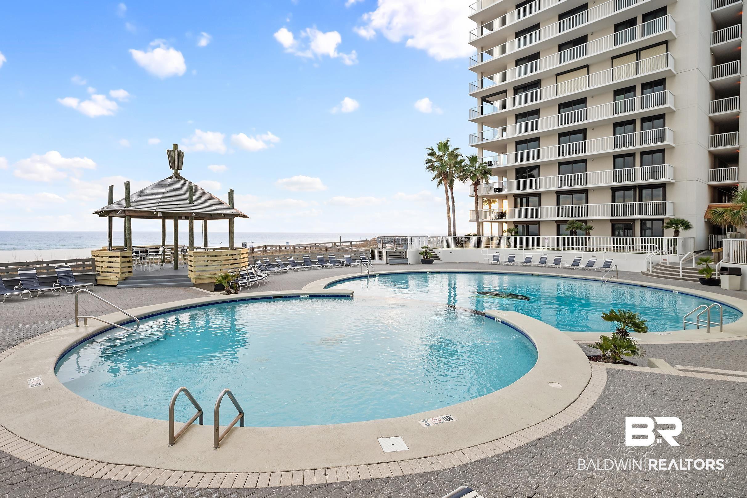 Image 4: Community pool featuring a patio
