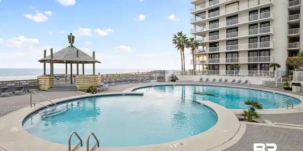 Image 4: Community pool featuring a patio