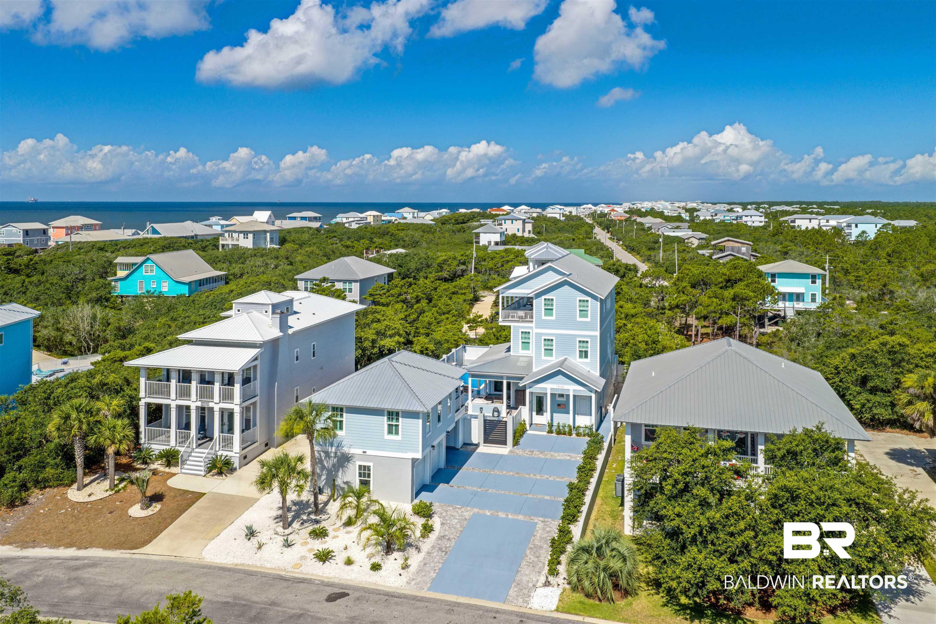 Image 2: Coastal community featuring a collection of properties amidst lush natural landscaping
