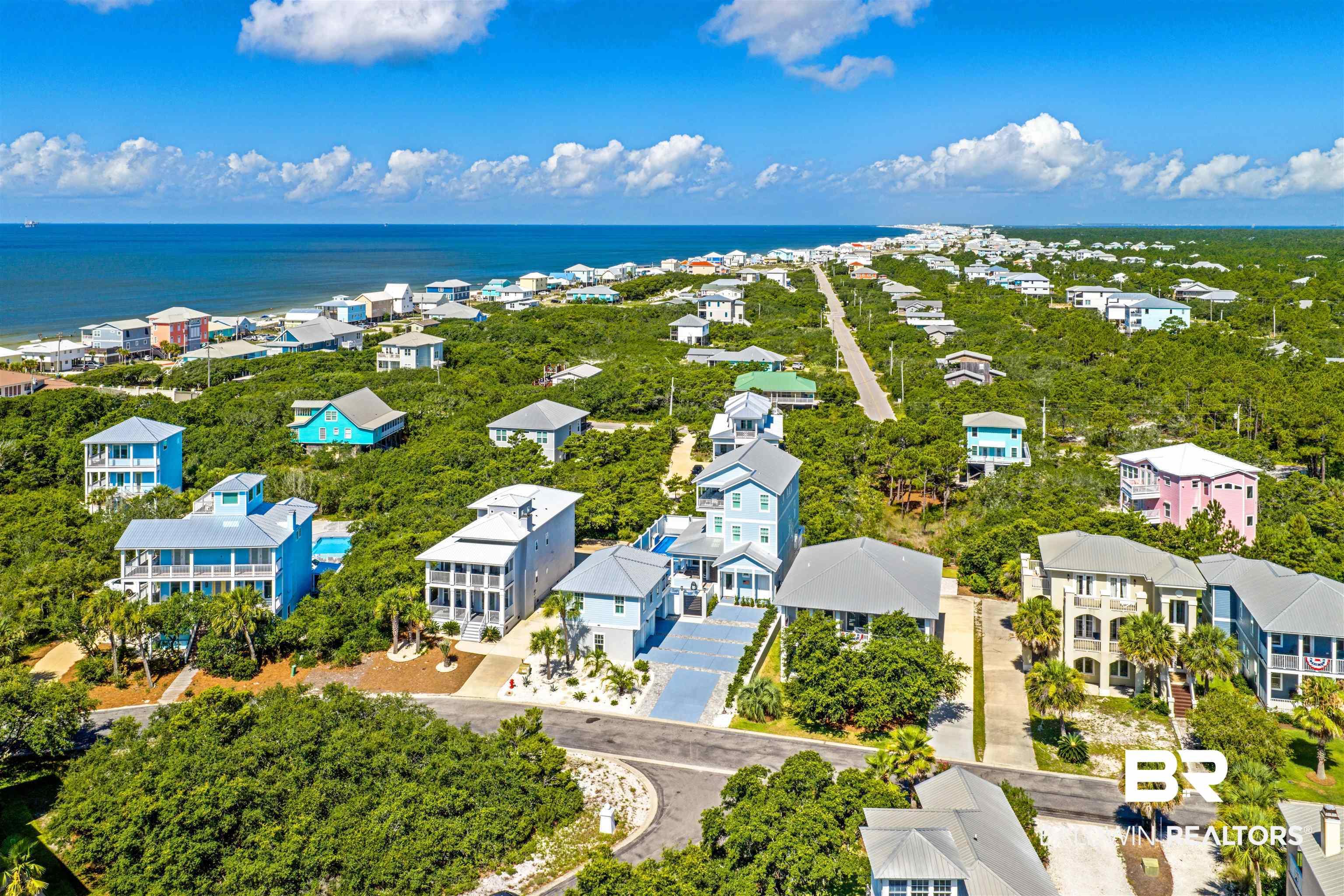 Image 3: Coastal community featuring a dense tree canopy and numerous homes with varying architectural styles