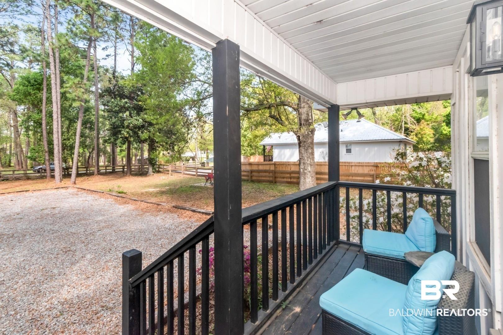 Image 3: Porch featuring a fenced backyard