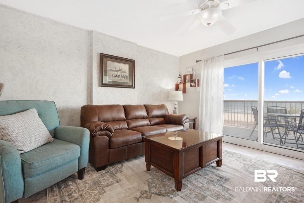 Image 4: Living room featuring a water view and ceiling fan