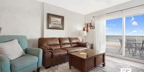 Image 4: Living room featuring a water view and ceiling fan
