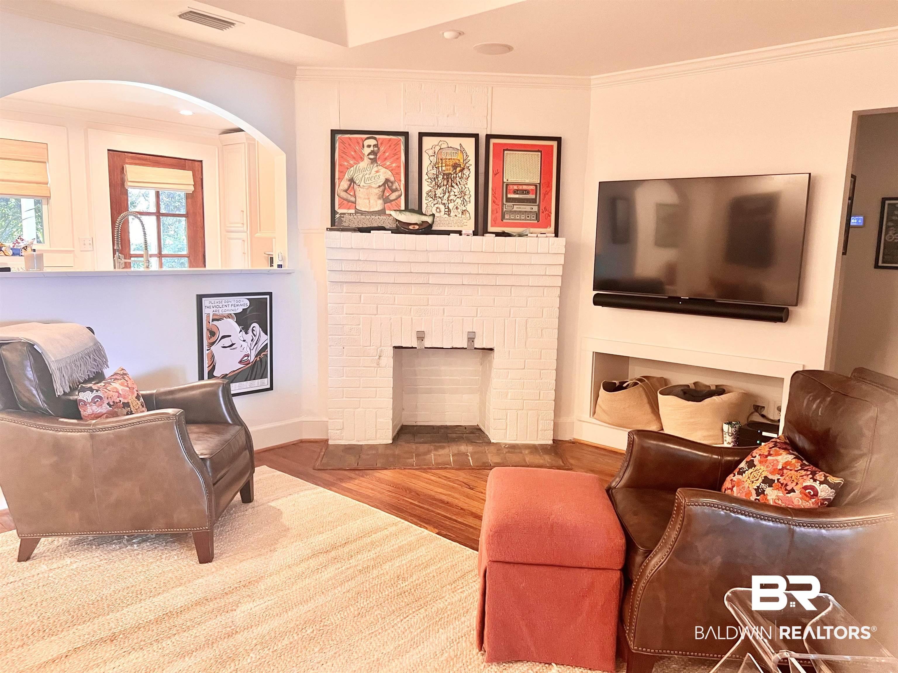 Image 3: Living room featuring a fireplace, sink, hardwood / wood-style floors, and ornamental molding