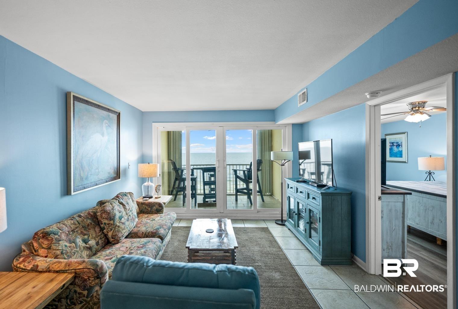 Image 4: Living room with light tile patterned flooring and a ceiling fan