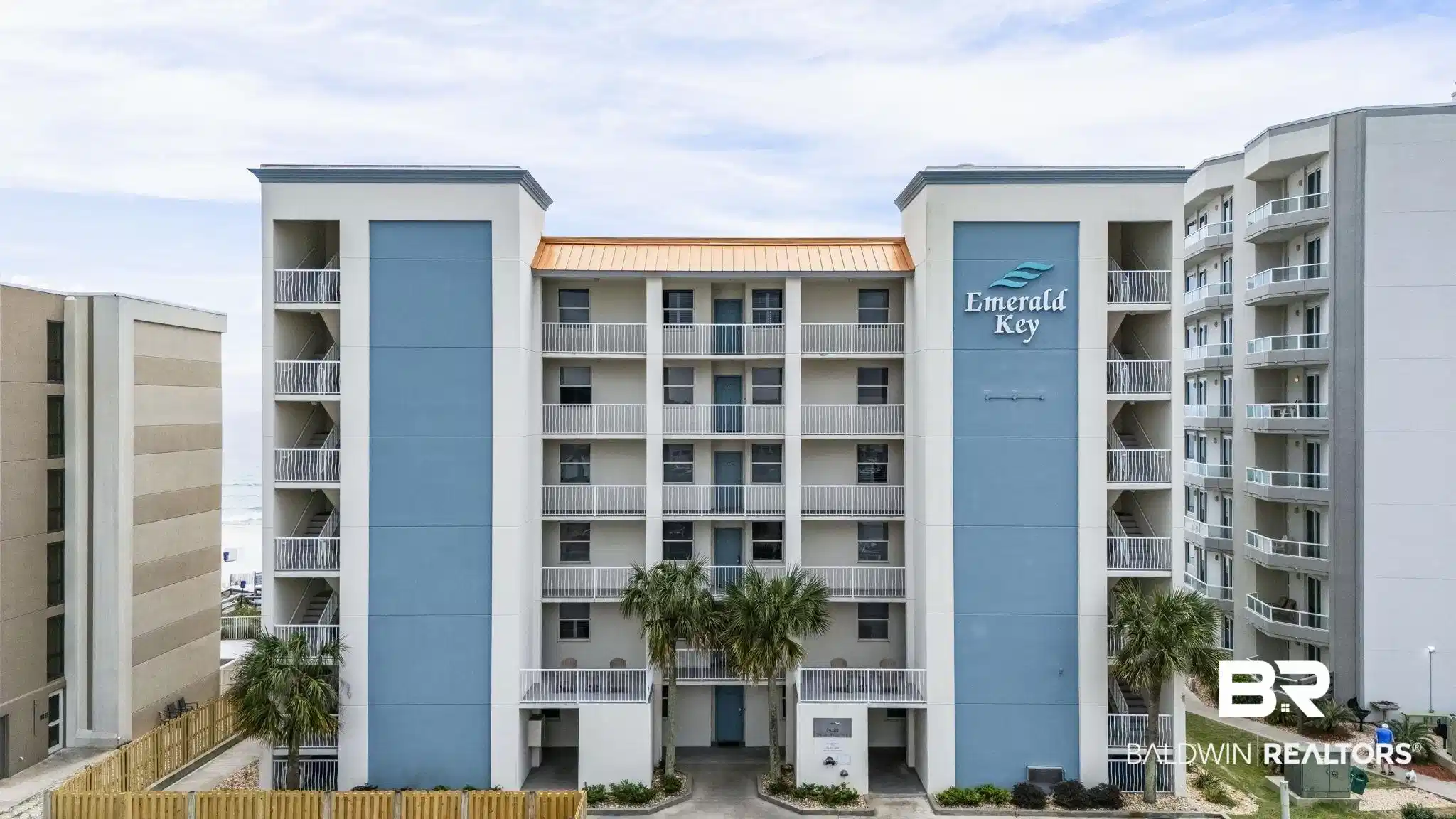 Image 1: Multi-story building featuring a prominent "Emerald Key" sign, blue accent panels, and multiple balconies