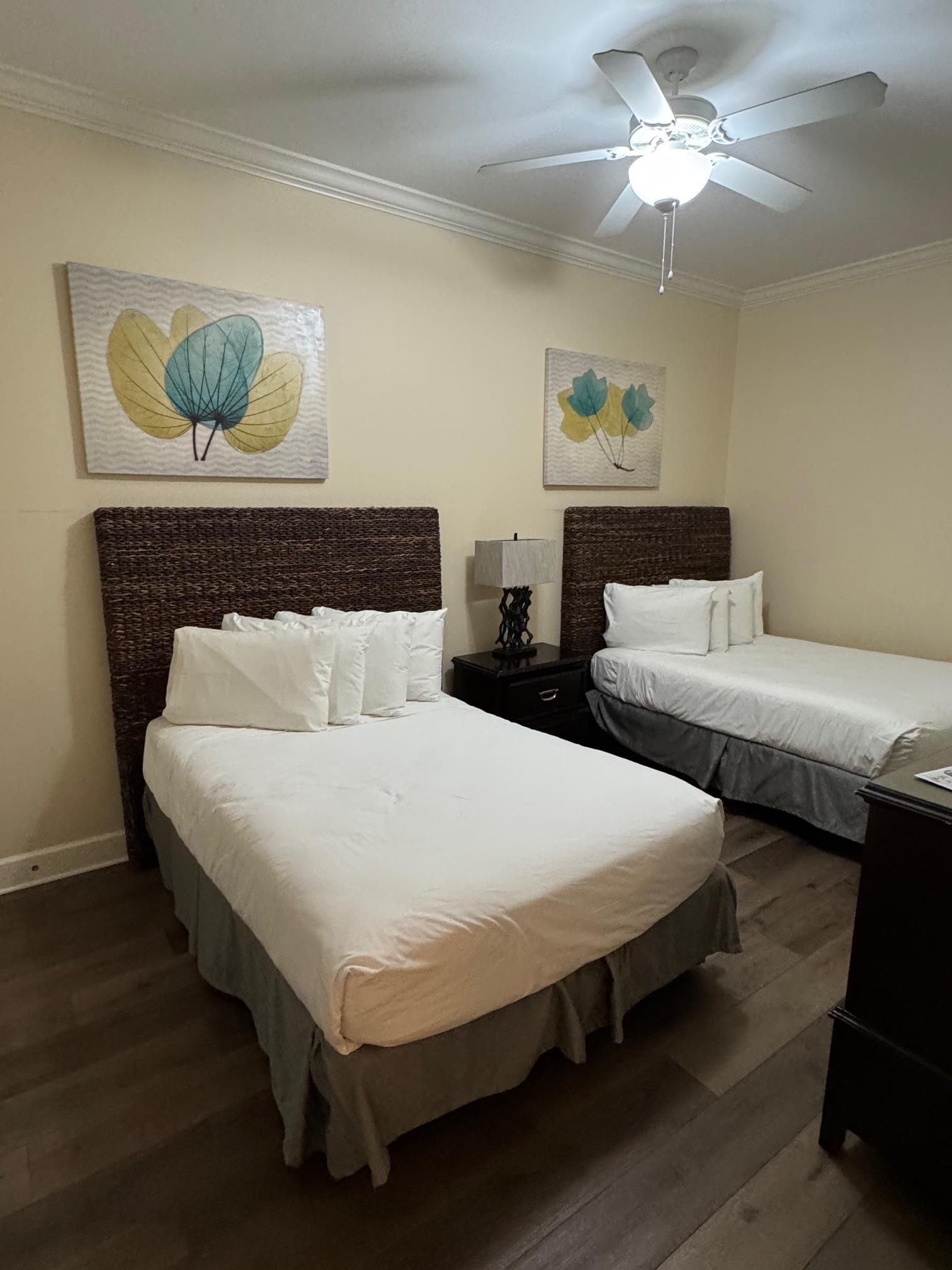 Image 3: Bedroom with dark hardwood / wood-style flooring, ceiling fan, and crown molding