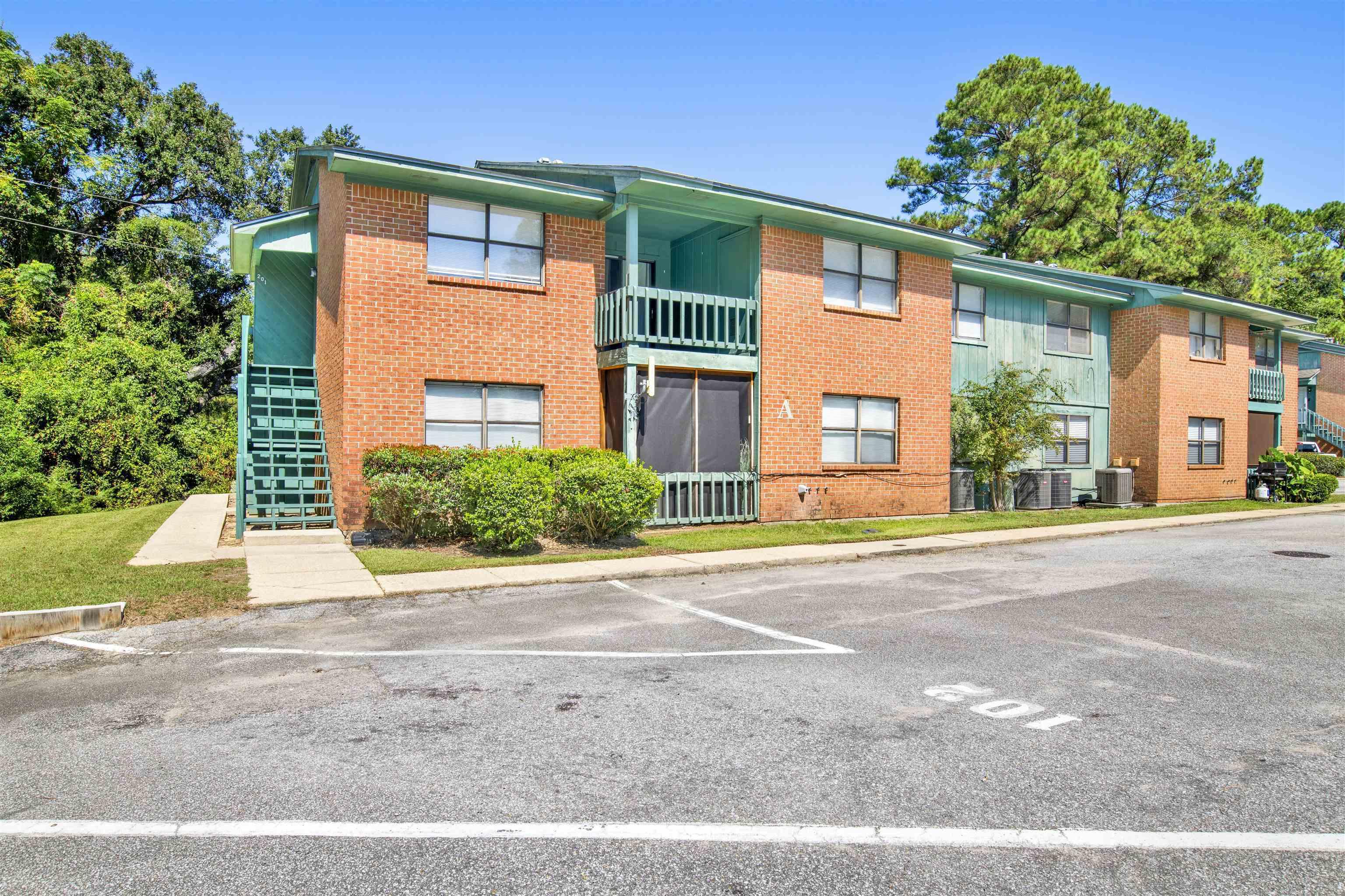 Image 1: View of property featuring uncovered parking and stairway