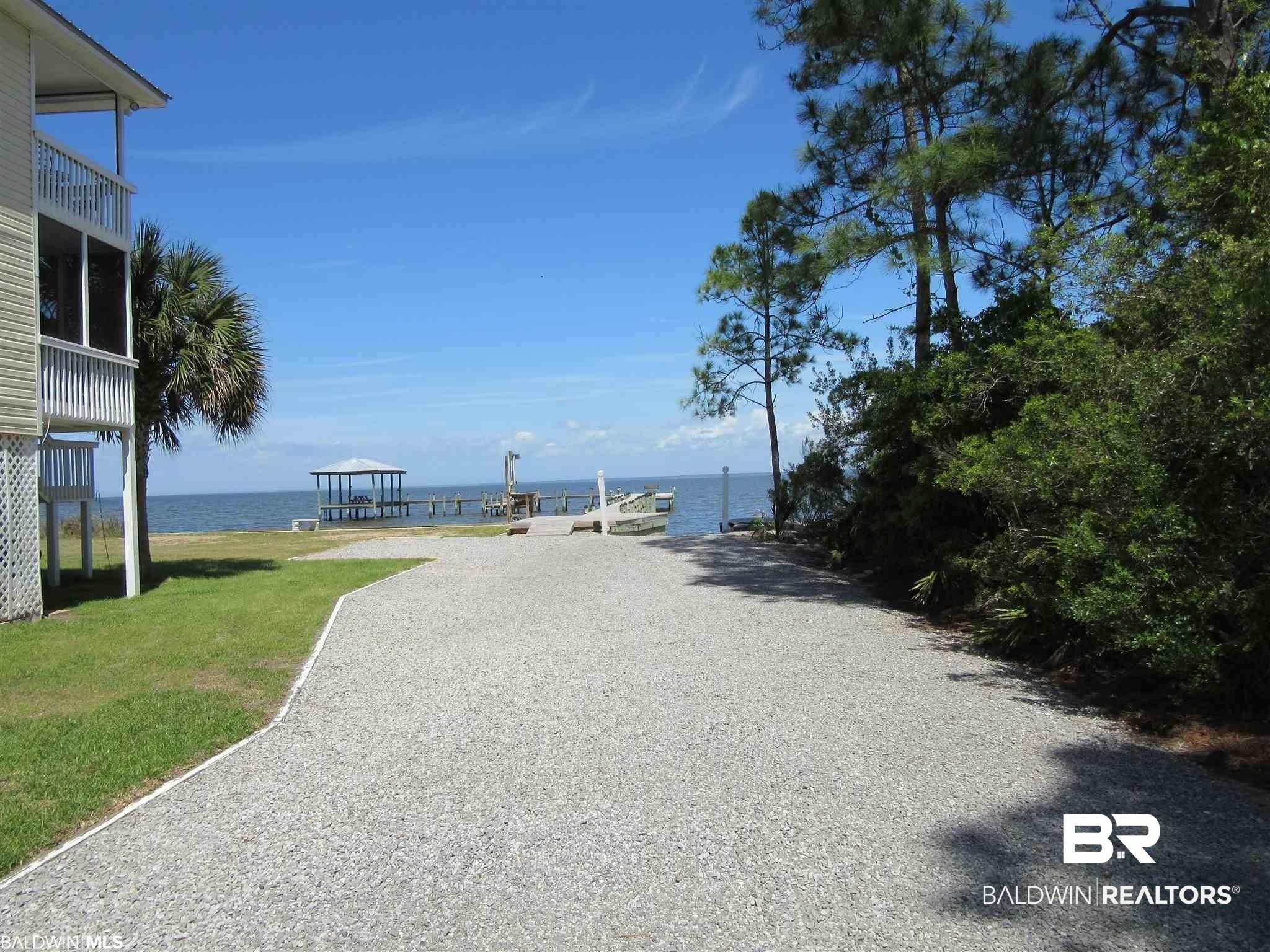 Image 4: View of dirt / gravel road featuring a boat ramp and a water view