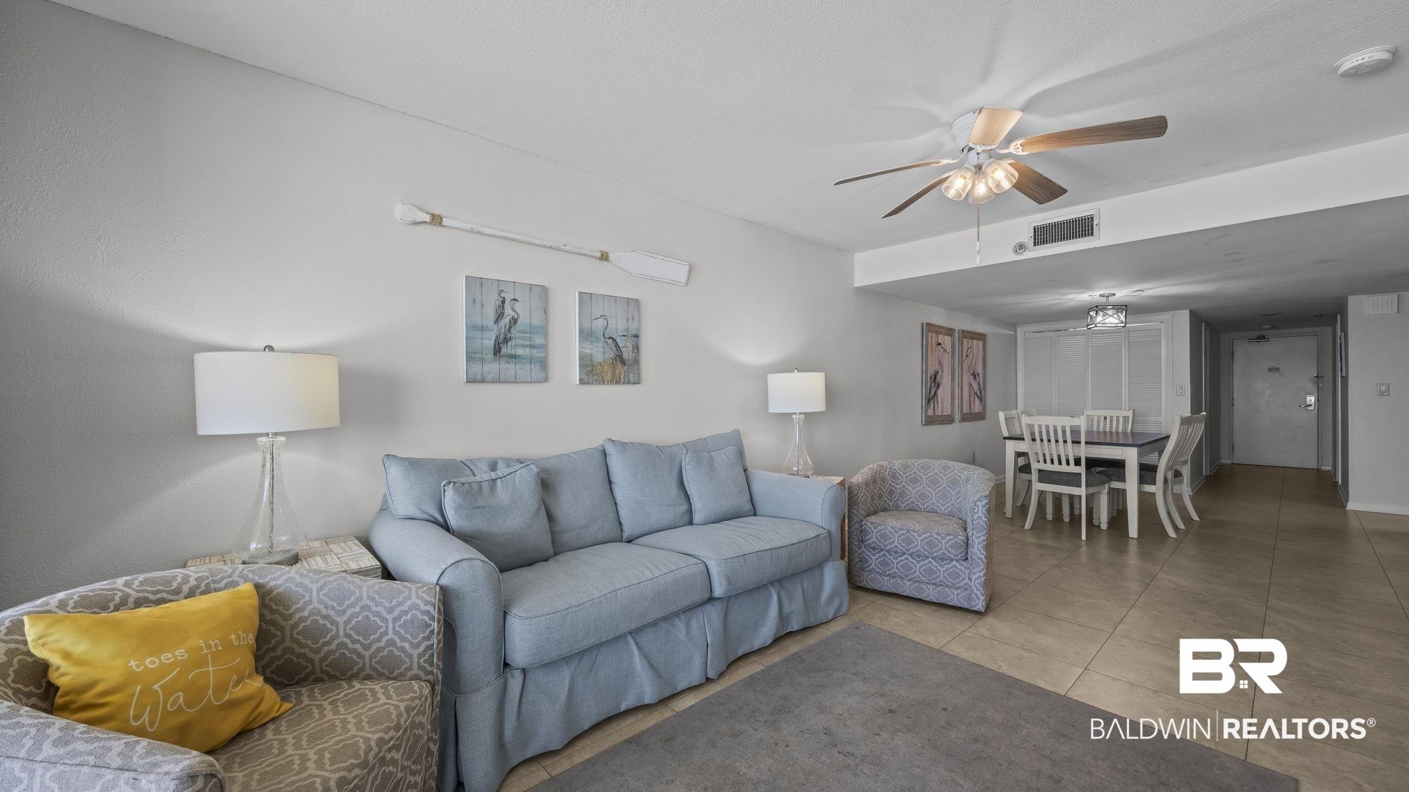Image 3: Living room featuring a ceiling fan and tile patterned floors