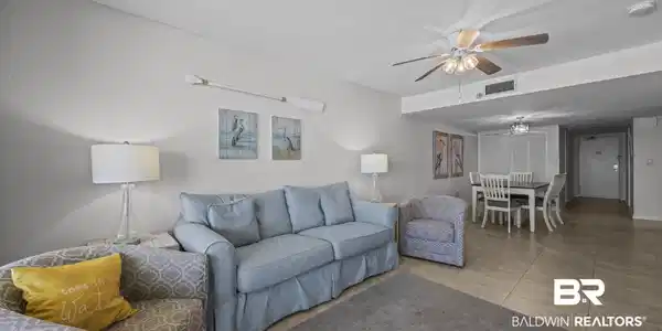 Image 3: Living room featuring a ceiling fan and tile patterned floors