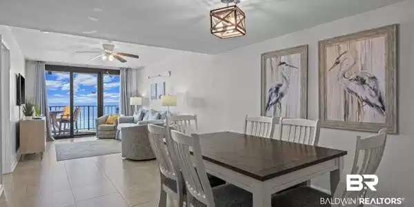 Image 4: Tiled dining room featuring expansive windows and a ceiling fan