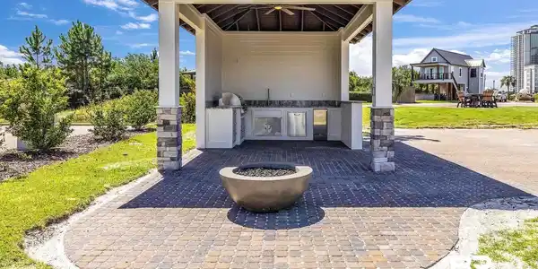 Image 3: View of patio featuring a fire pit, an outdoor kitchen, a ceiling fan, grilling area, and a gazebo