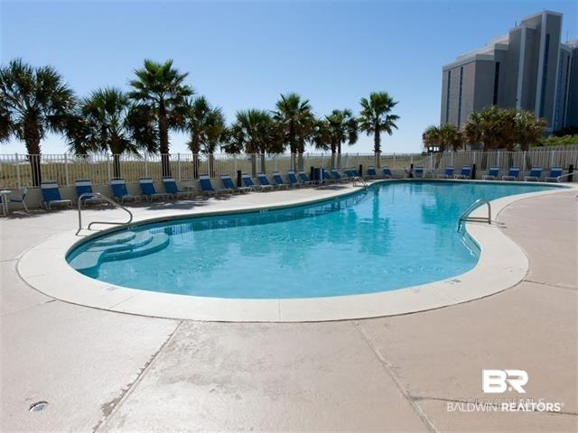 Image 3: Community pool with a patio area