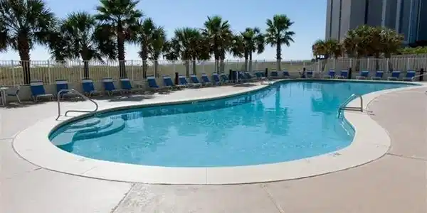 Image 3: Community pool with a patio area