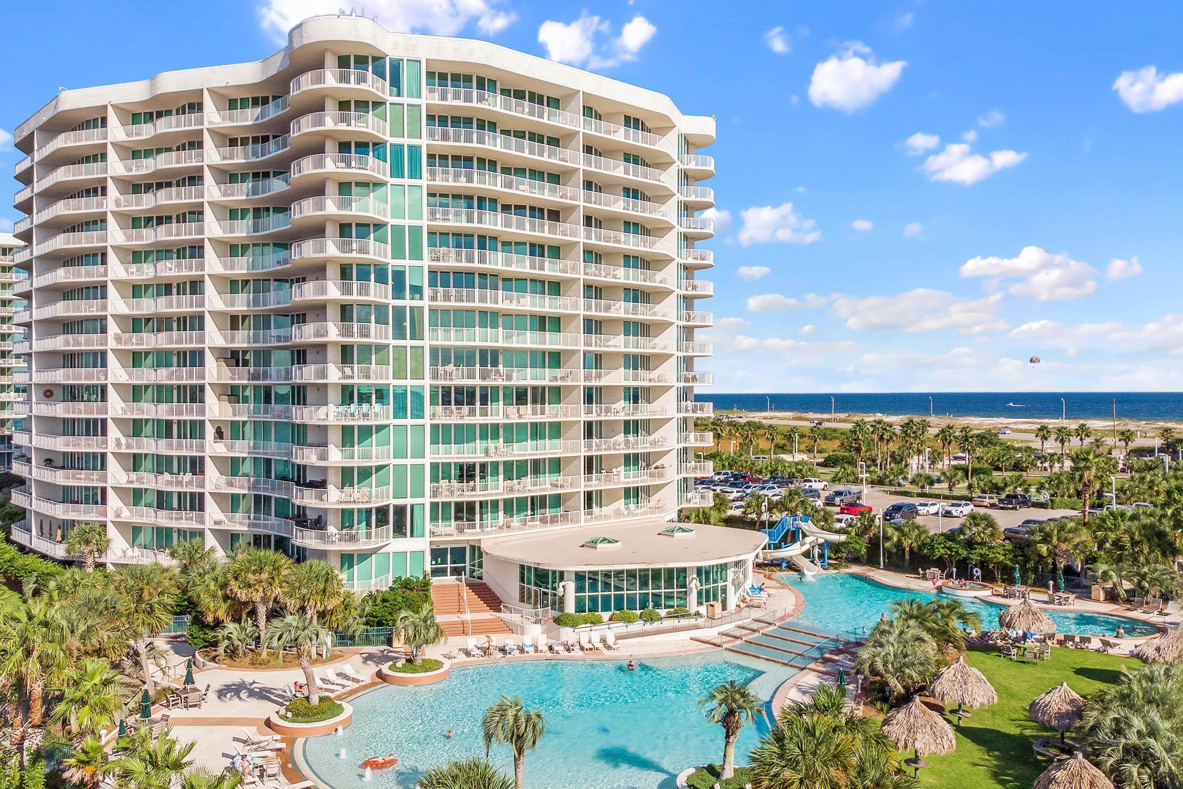 Image 2: View of apartment building / complex featuring a community pool and a water view