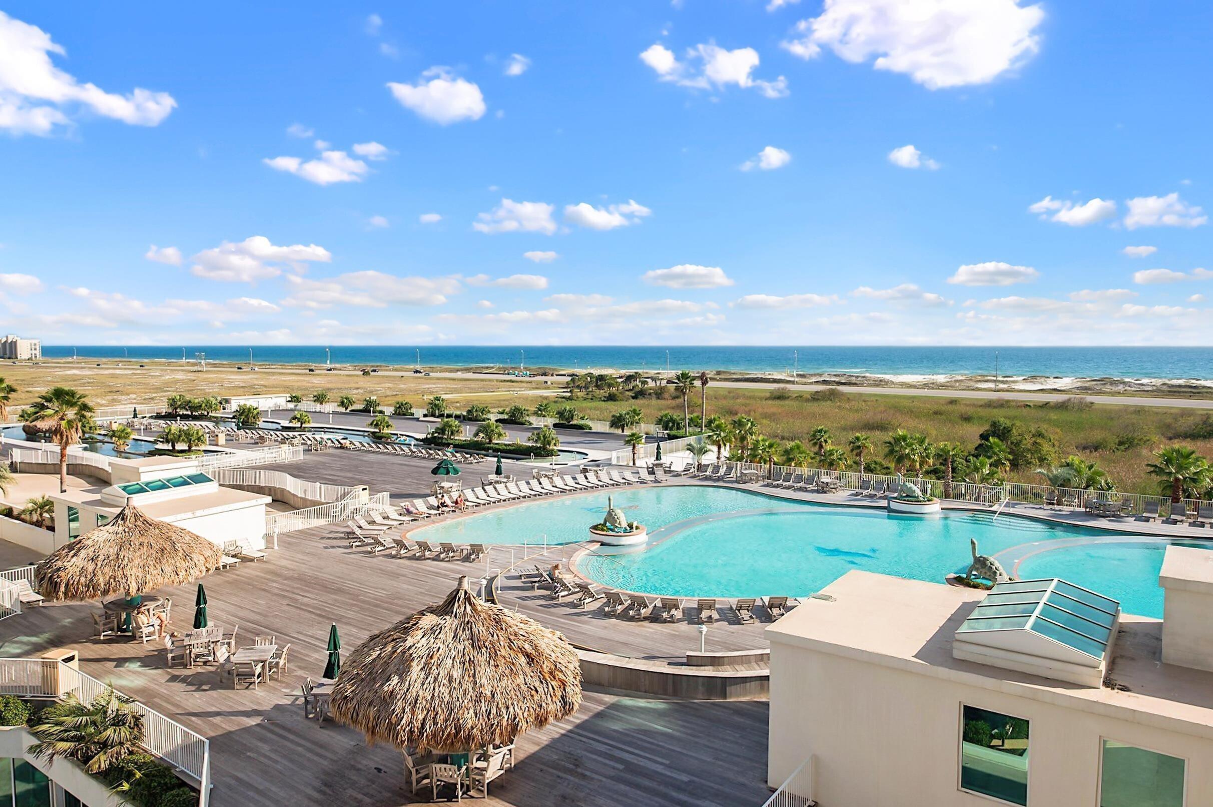 Image 4: Community pool featuring a water view and a patio area