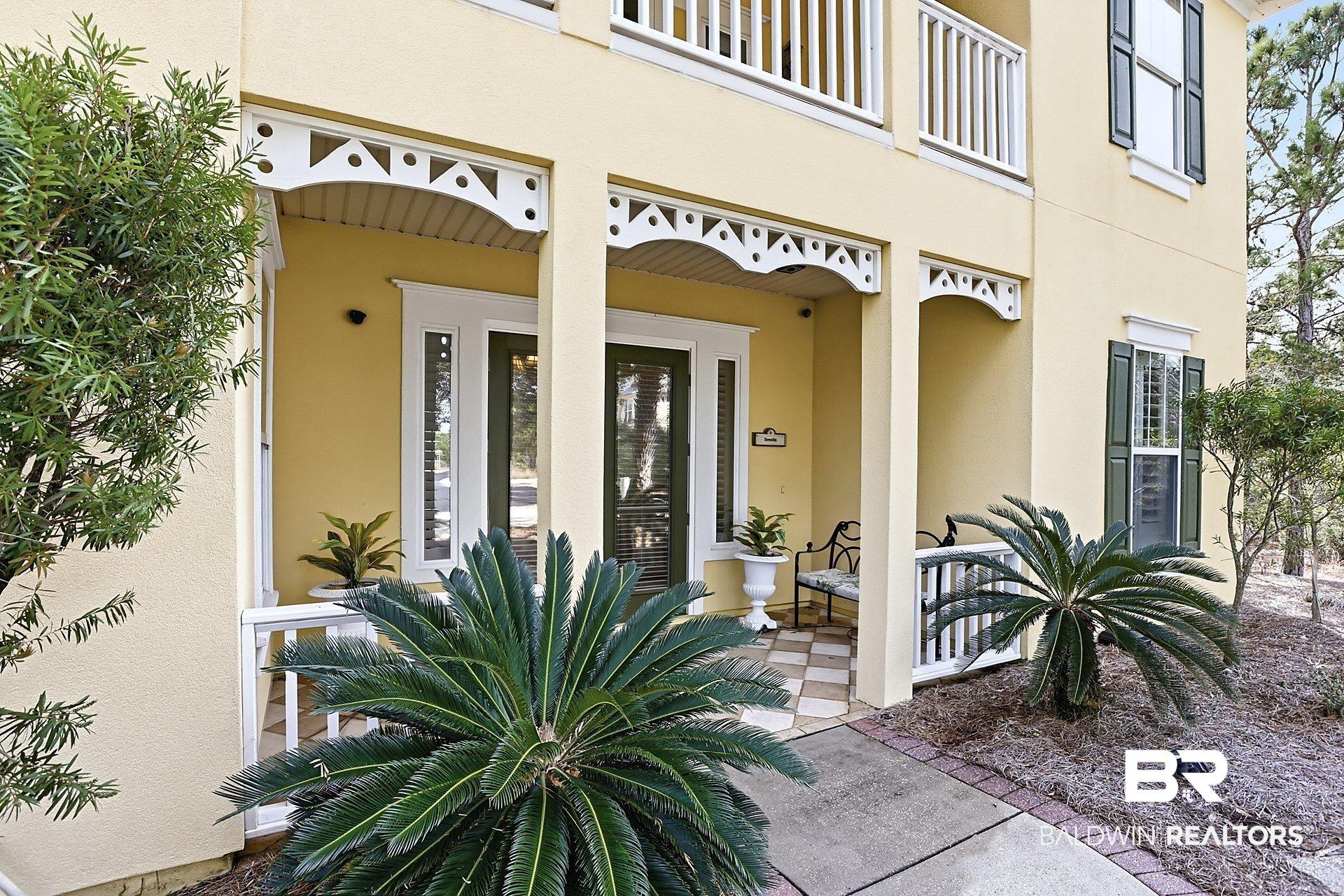 Image 2: Property entrance featuring stucco siding