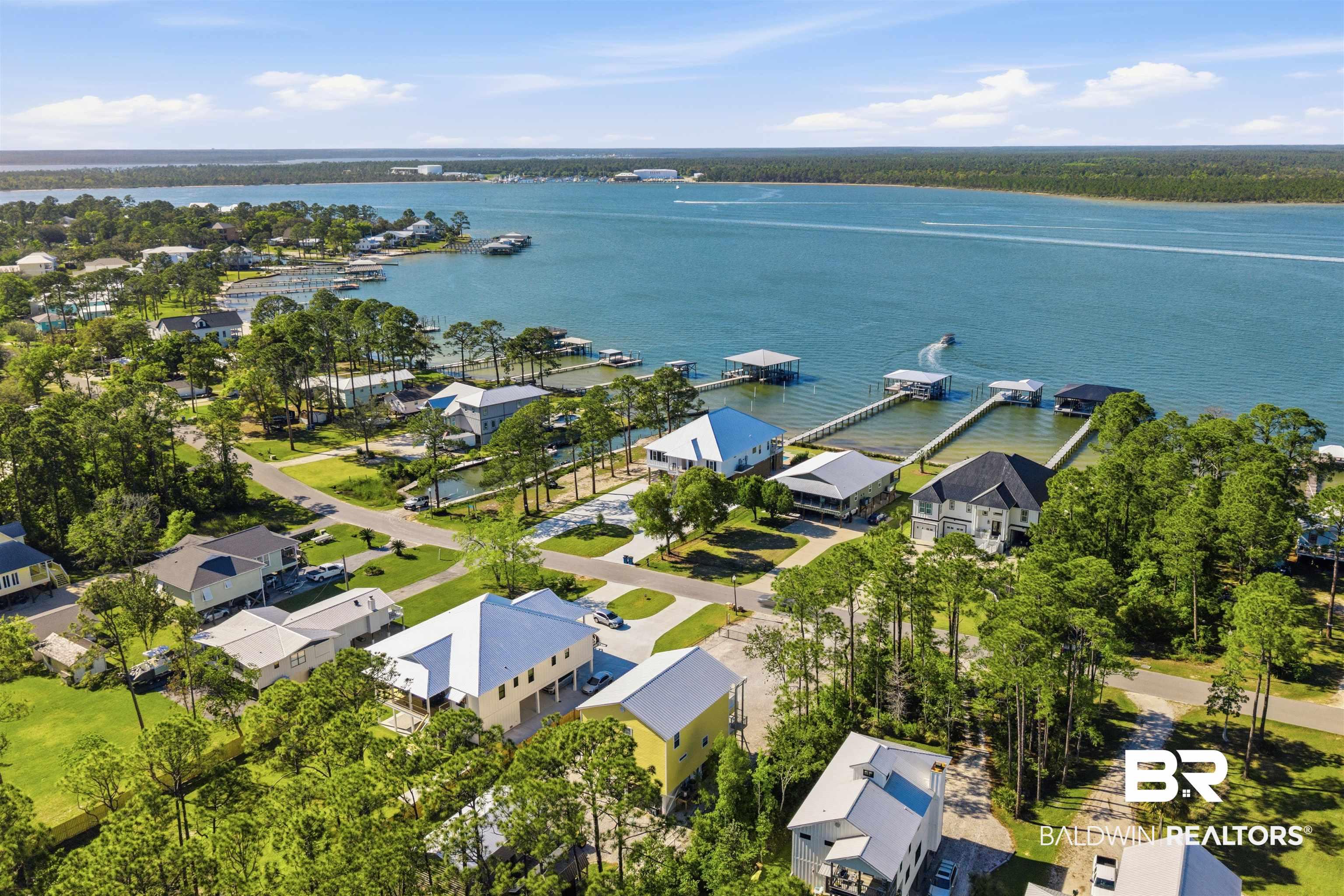 Image 4: Aerial perspective of suburban area with a nearby body of water