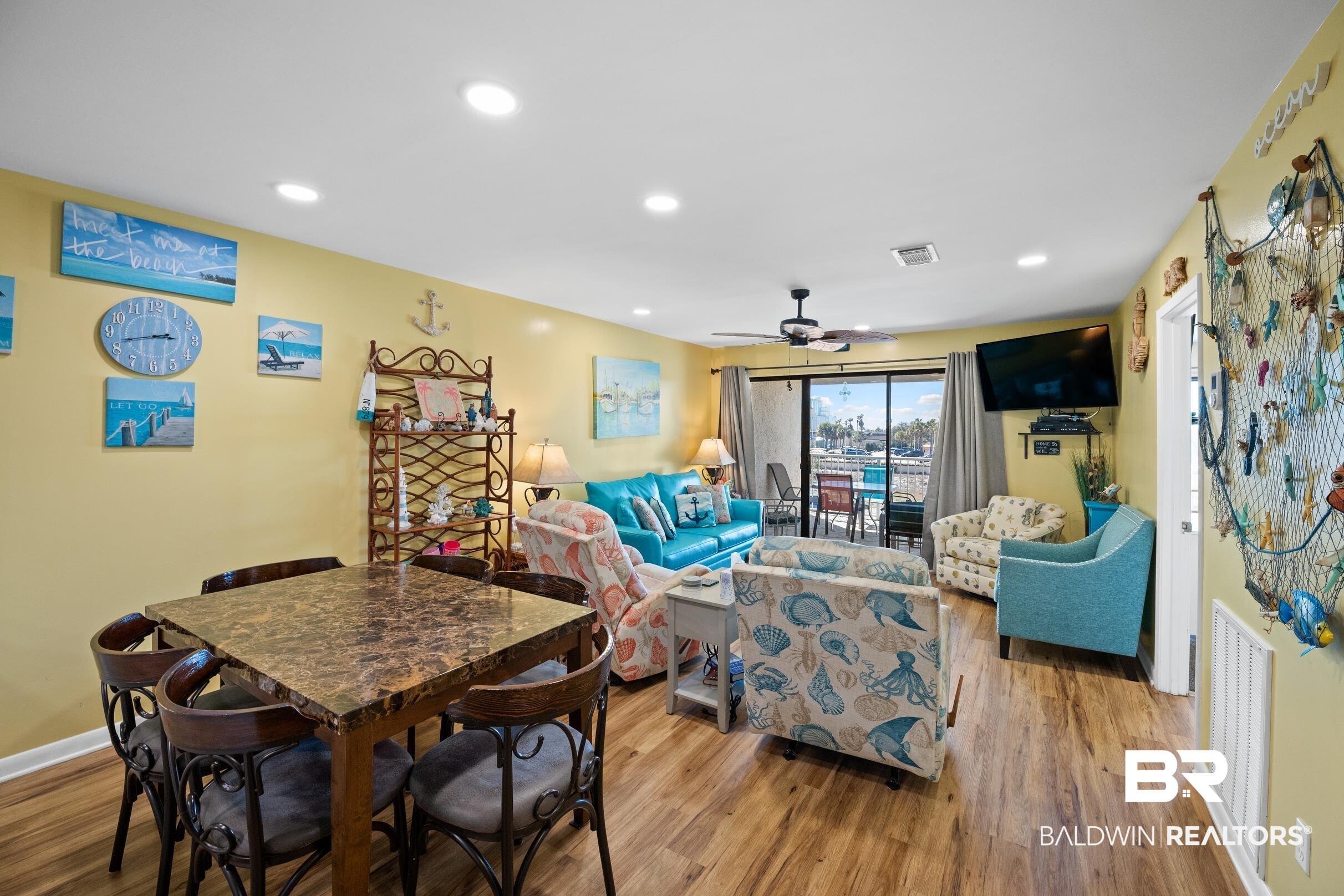 Image 3: Living room with baseboards, visible vents, wood finished floors, and recessed lighting