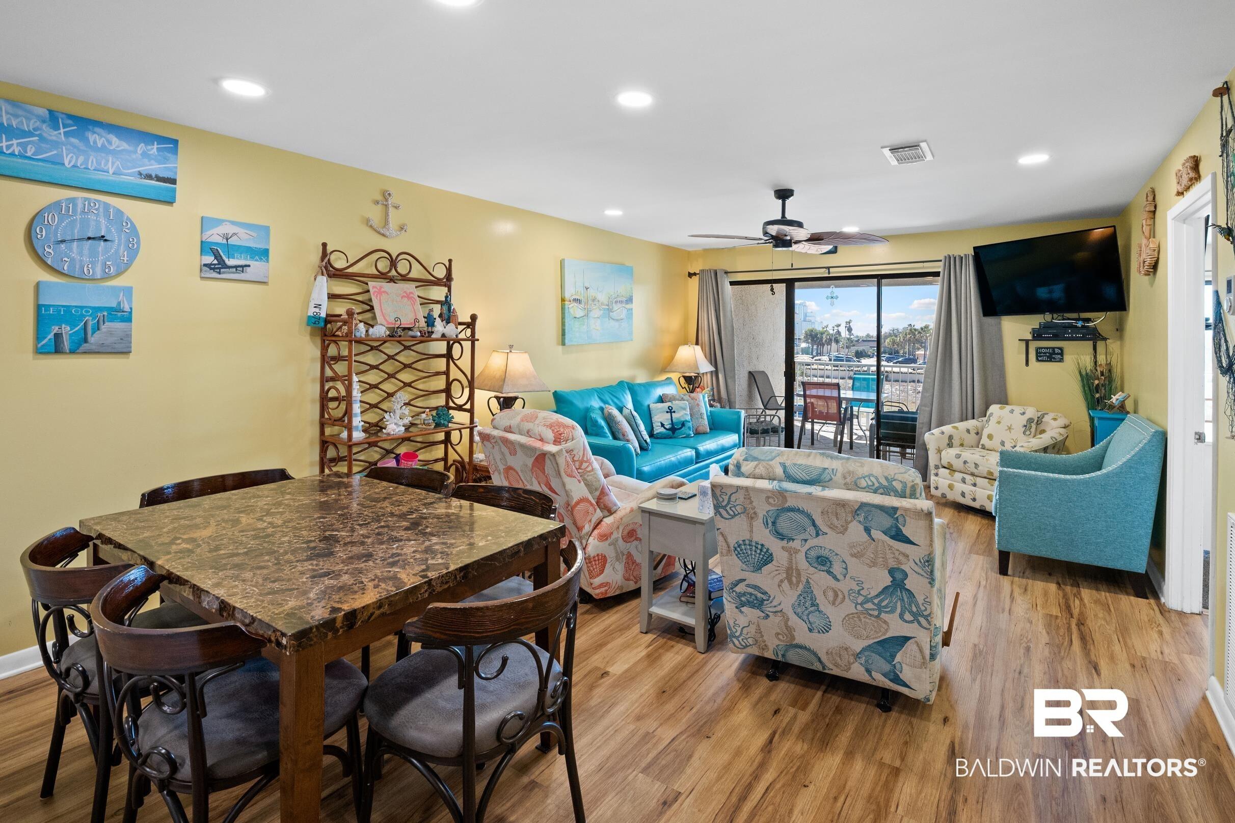 Image 4: Dining space with a ceiling fan, recessed lighting, visible vents, and wood finished floors