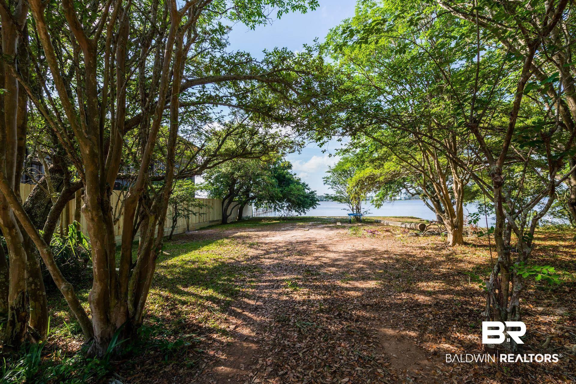 Image 4: View of yard with a water view and fence