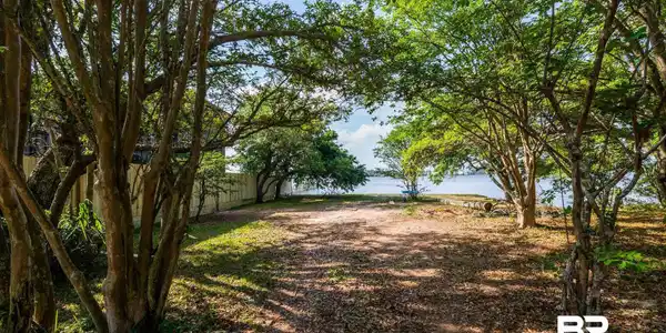 Image 4: View of yard with a water view and fence