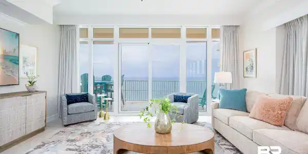 Image 2: Spacious living area featuring large sliding glass doors, crown molding, a ceiling fan, and a built-in credenza