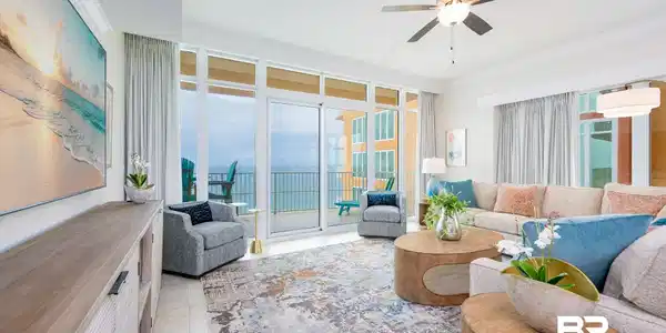 Image 3: Spacious living area featuring floor-to-ceiling sliding glass doors, a modern ceiling fan, crown molding, and tiled flooring