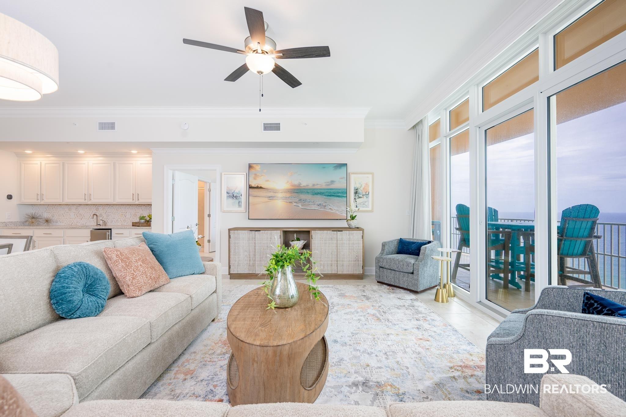 Image 4: Open-concept living area featuring an integrated wet bar, crown molding, and recessed lighting