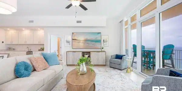 Image 4: Open-concept living area featuring an integrated wet bar, crown molding, and recessed lighting