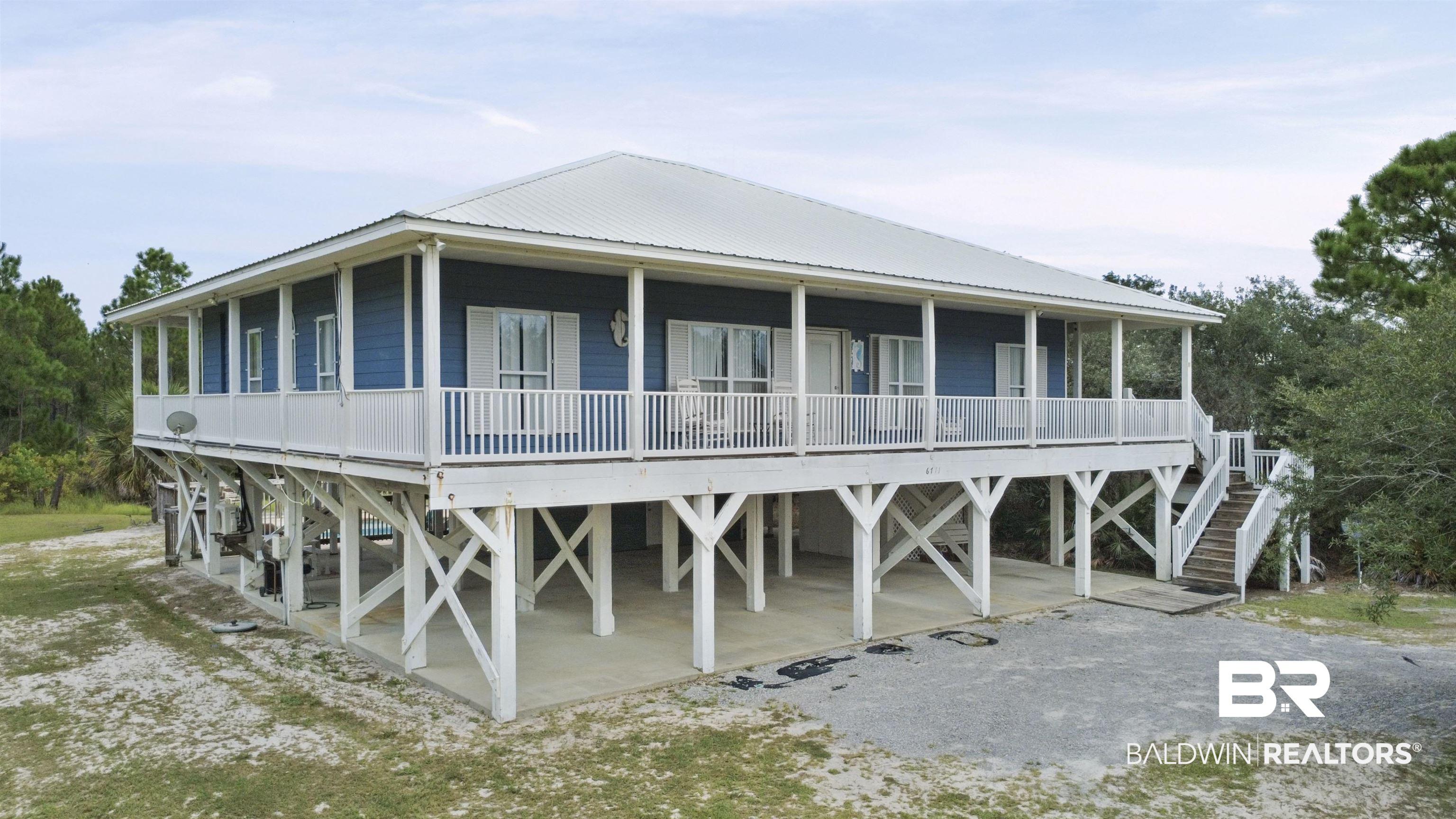 Image 2: Back of house with covered porch, a metal roof, and a carport