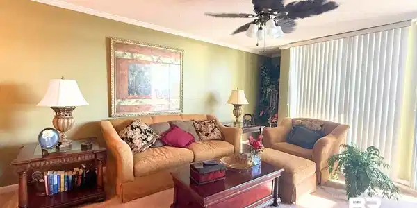 Image 3: Living area featuring ornamental molding, a textured ceiling, carpet, and ceiling fan