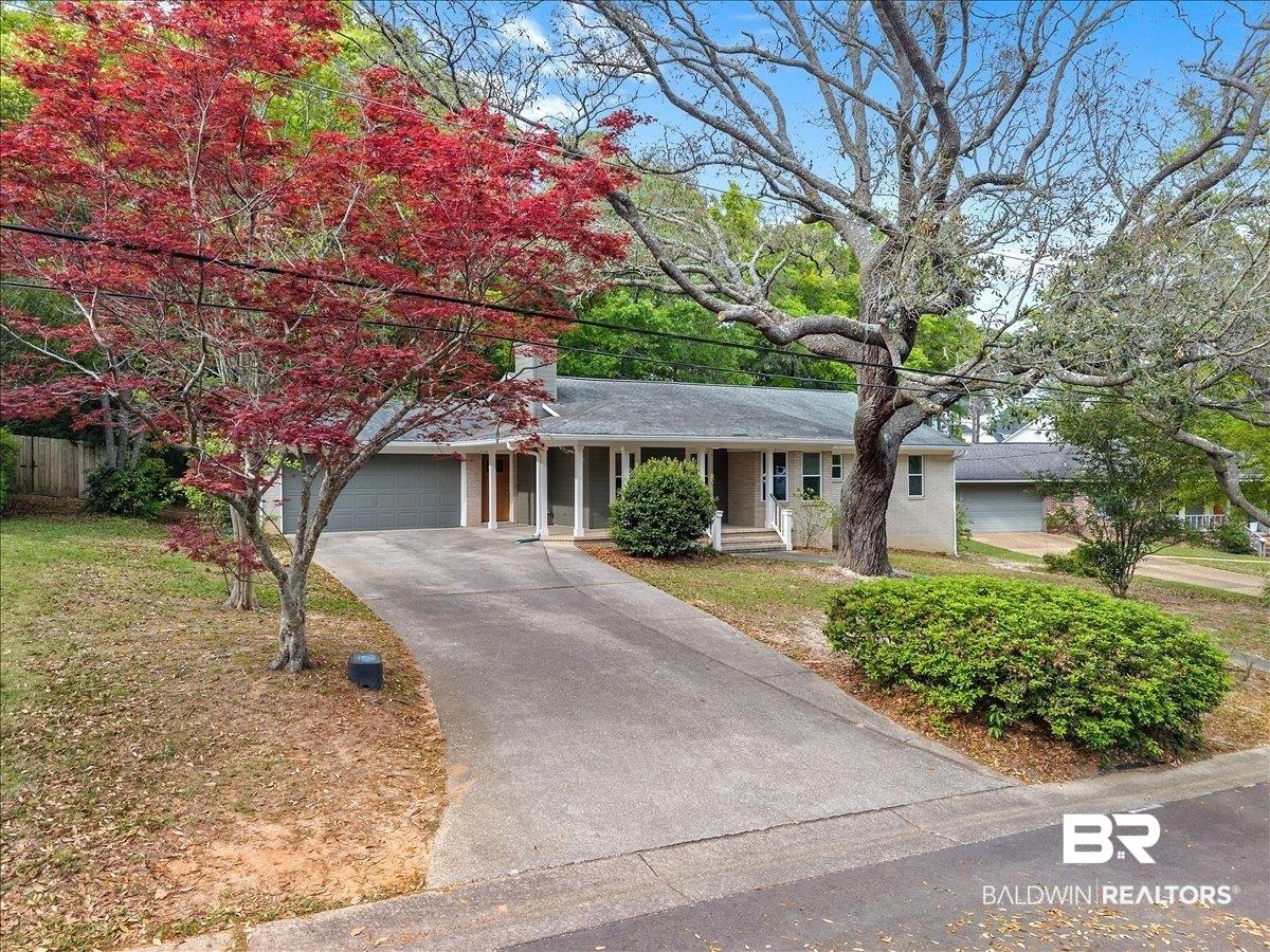 Image 3: Single story home with covered porch, an attached garage, driveway, and a front yard