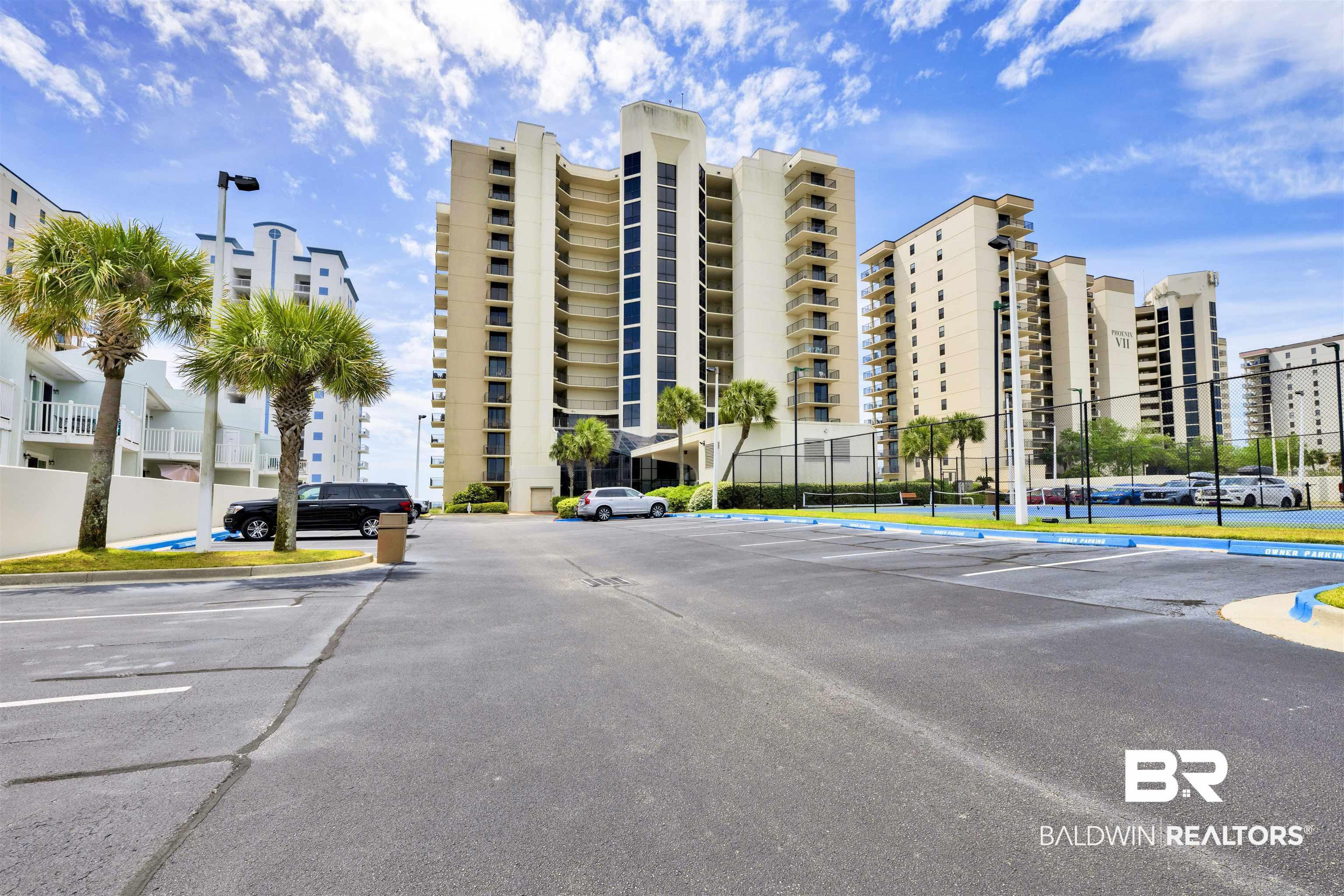 Image 2: View of apartment building / complex featuring uncovered parking