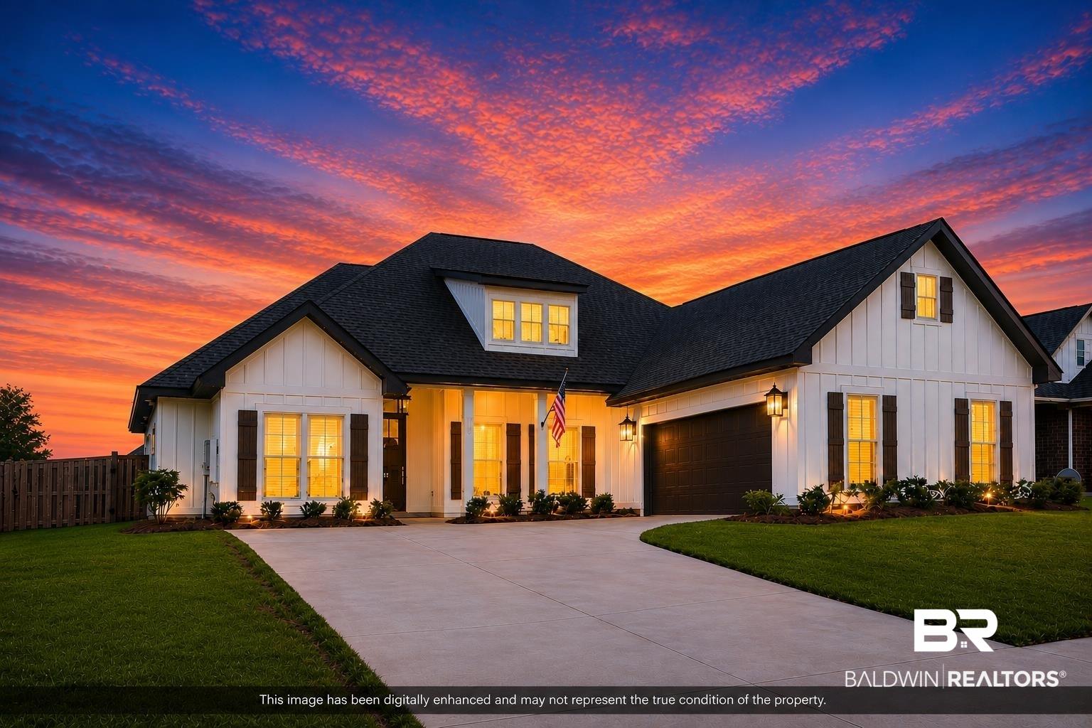 Image 3: Modern farmhouse-style residence featuring white board and batten siding, dark shingle roofing, dark wood window shutters, and a two-car garage
