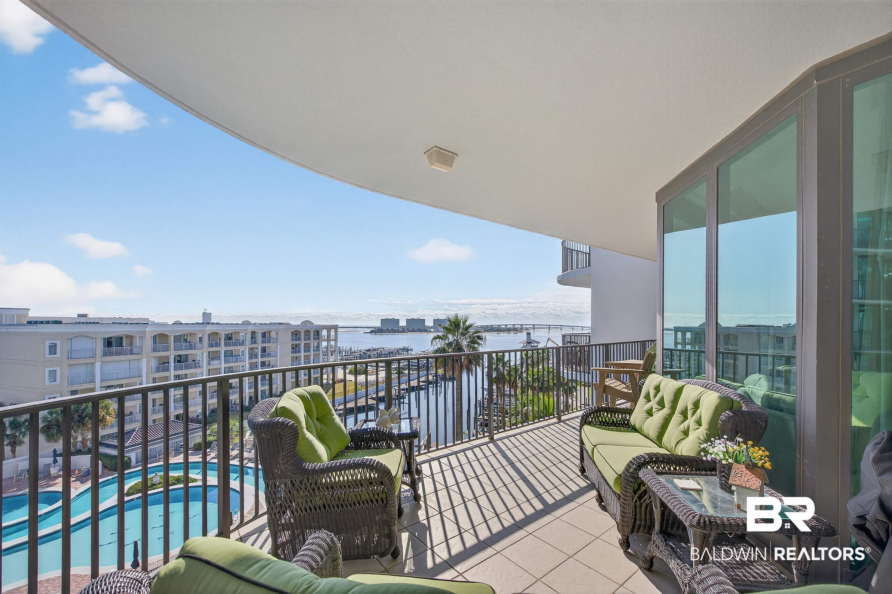 Image 3: Balcony with view of pool and a water view