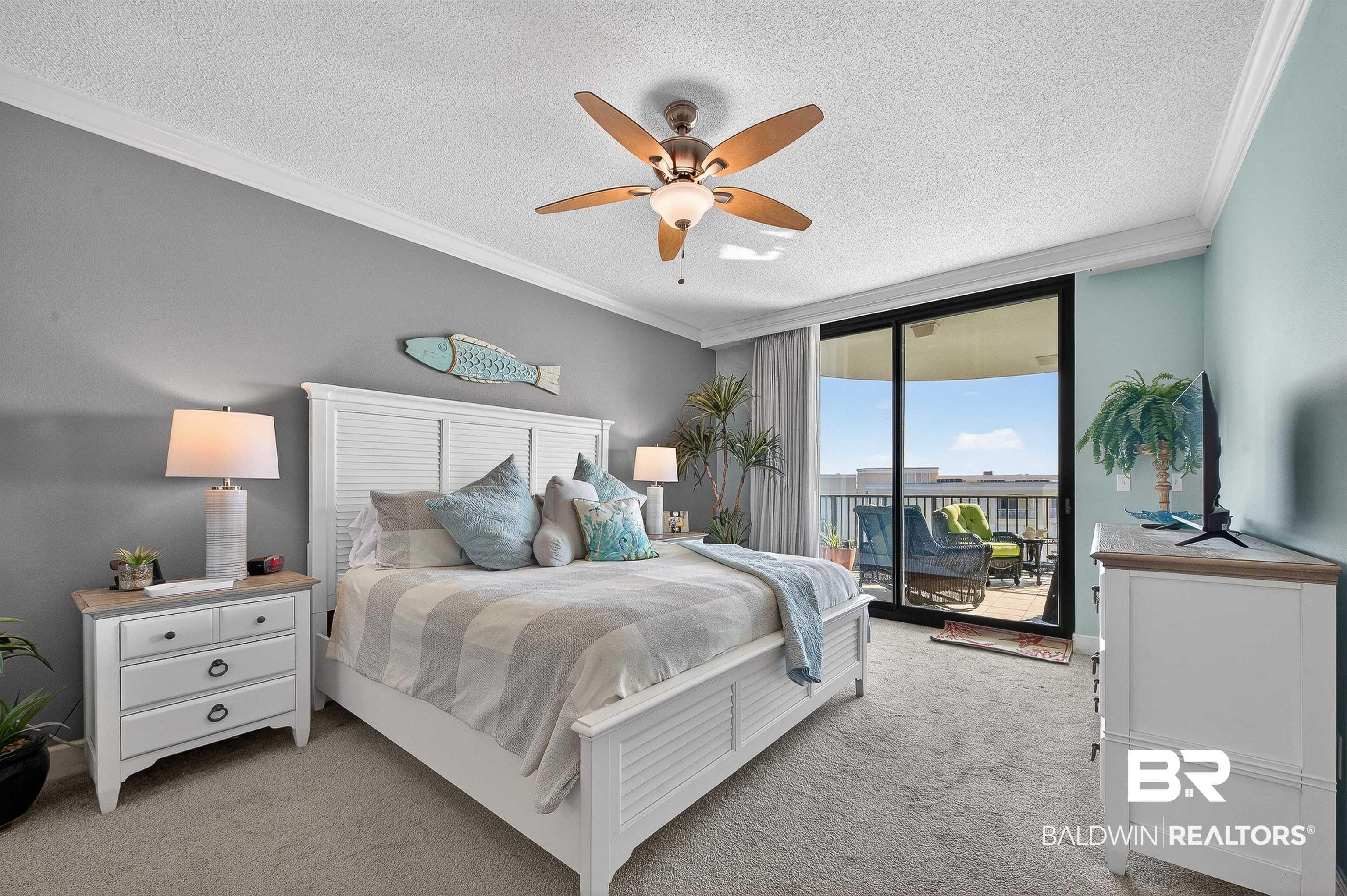 Image 4: Bedroom featuring ornamental molding, access to outside, a textured ceiling, carpet, and a ceiling fan