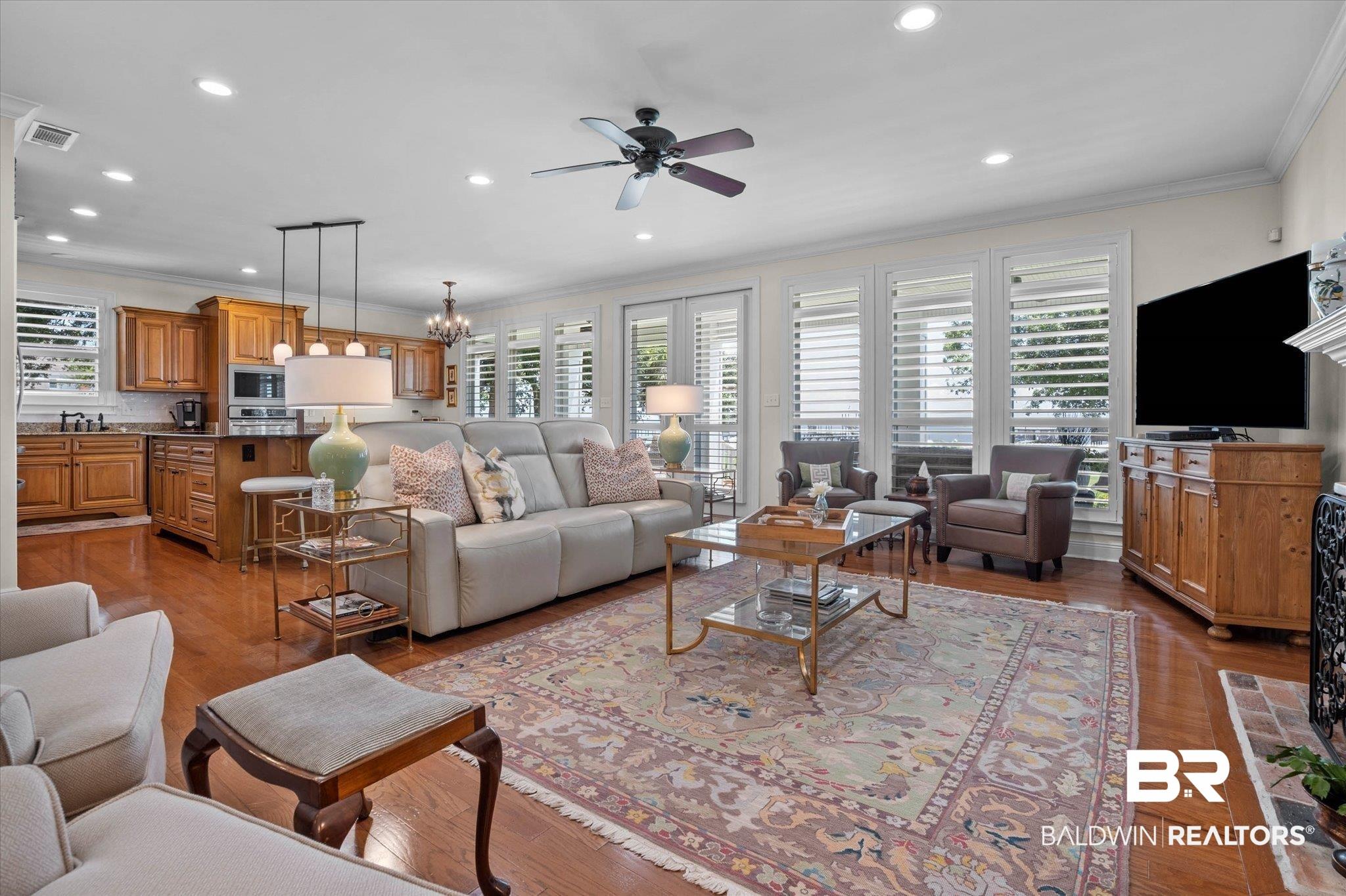 Image 2: Open-concept living space featuring wood-finish flooring, recessed lighting, and a ceiling fan
