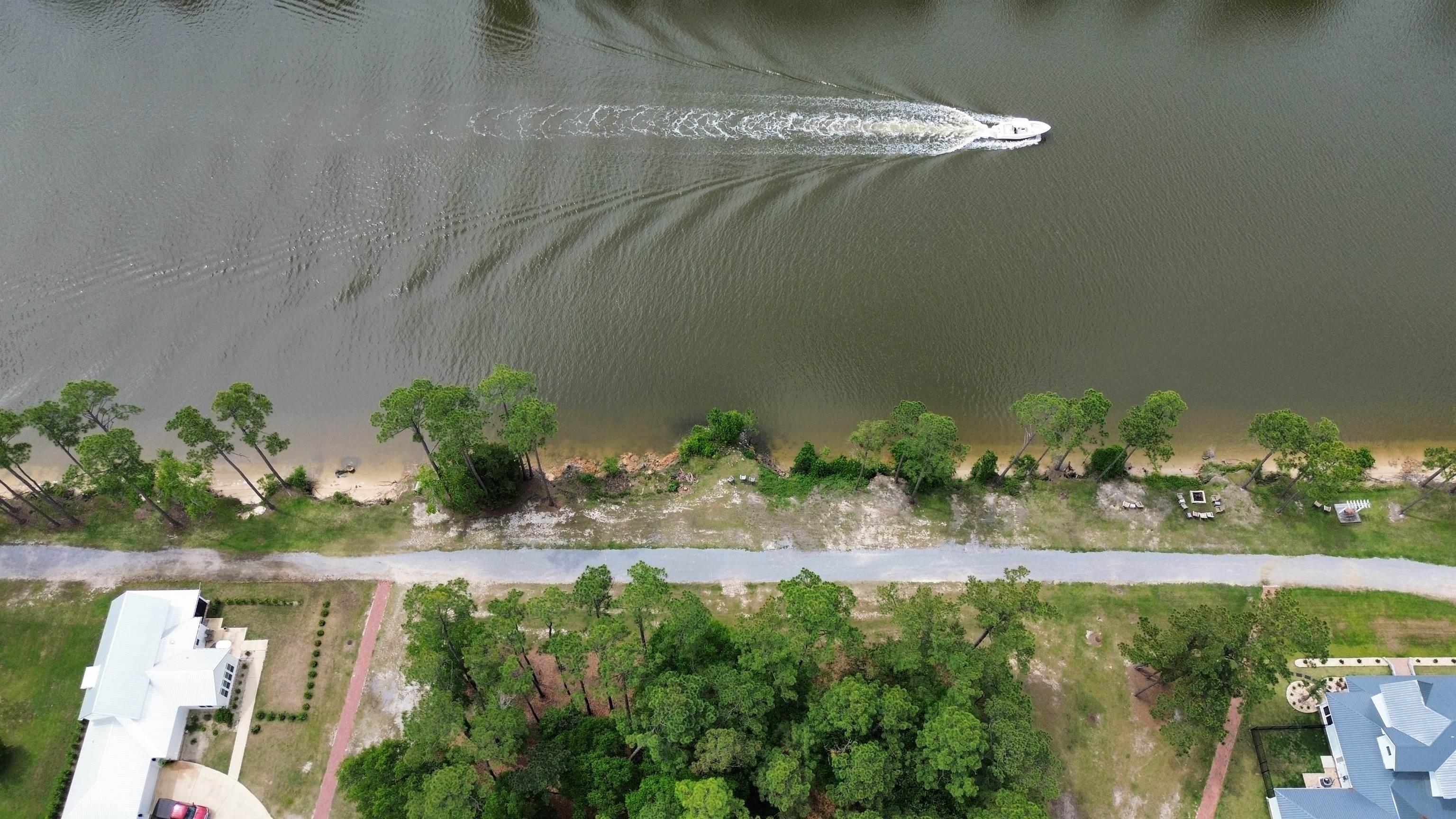Image 4: Aerial view of property's location with a large body of water