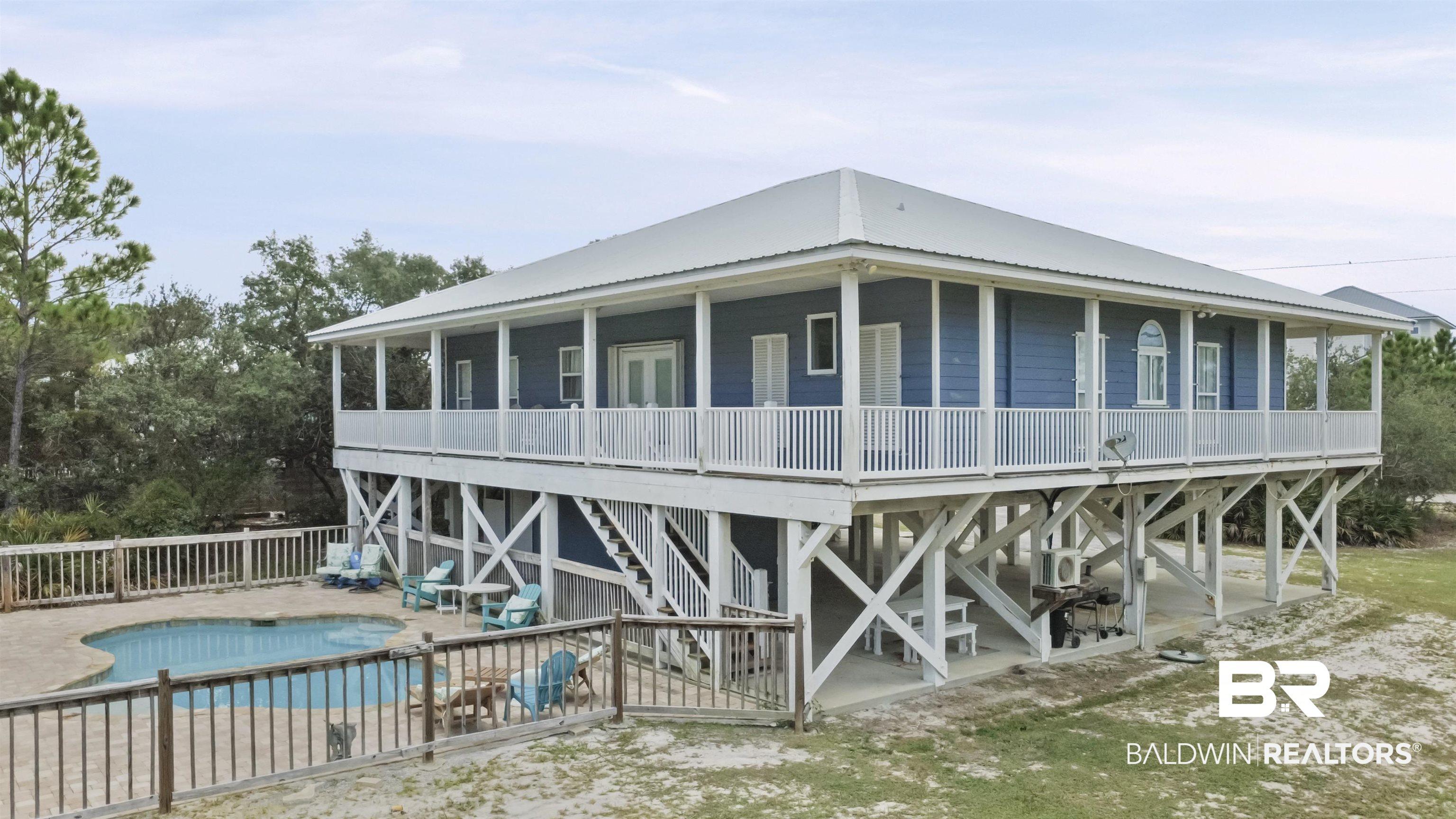 Image 3: Rear view of property featuring a patio area, a metal roof, and stairway