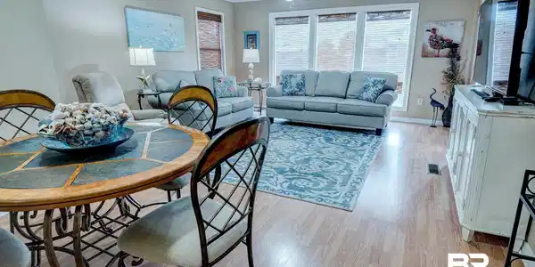Image 2: Living area with ornamental molding, light wood-style flooring, a ceiling fan, and a textured ceiling
