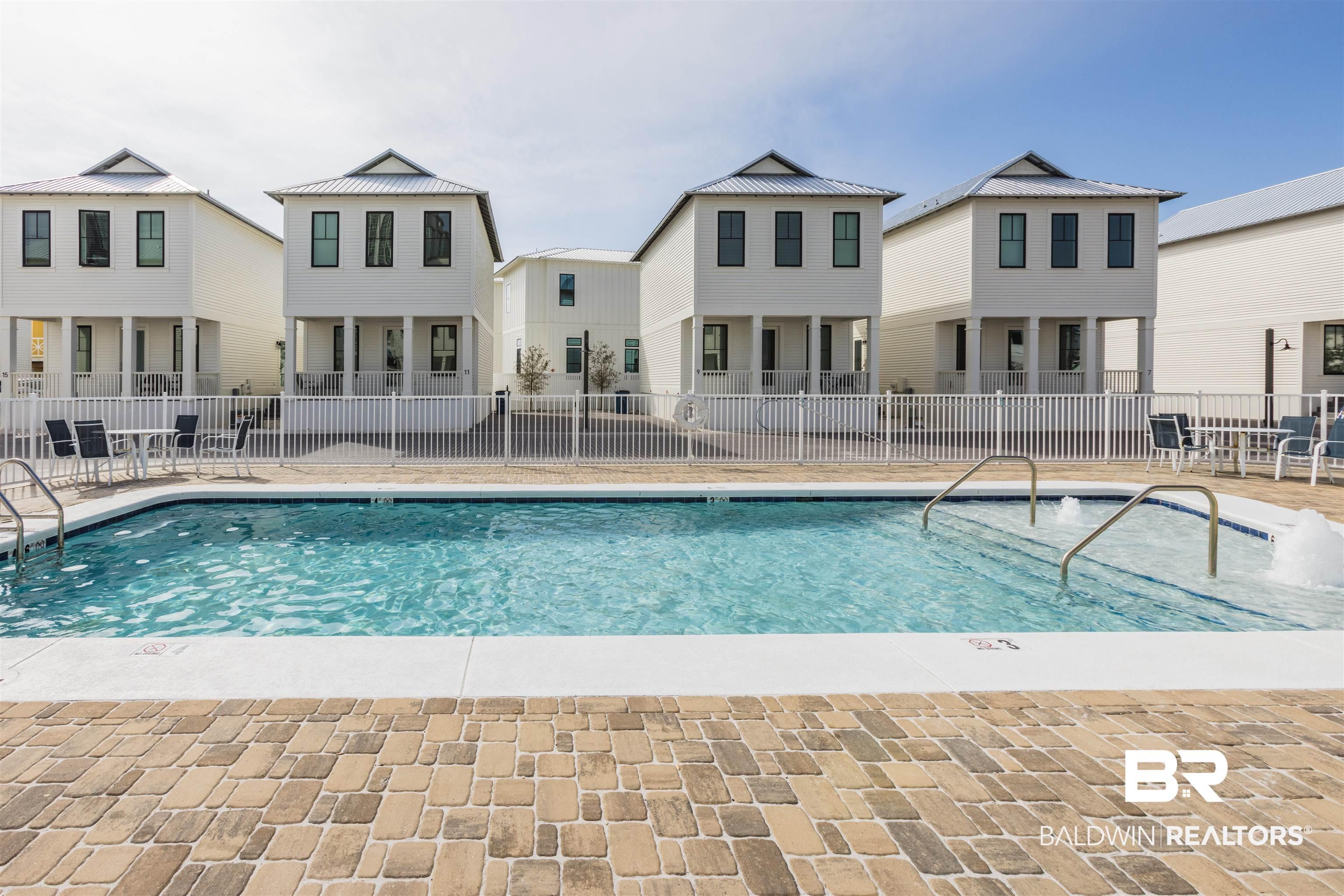 Image 3: Community pool featuring a residential view and a patio area