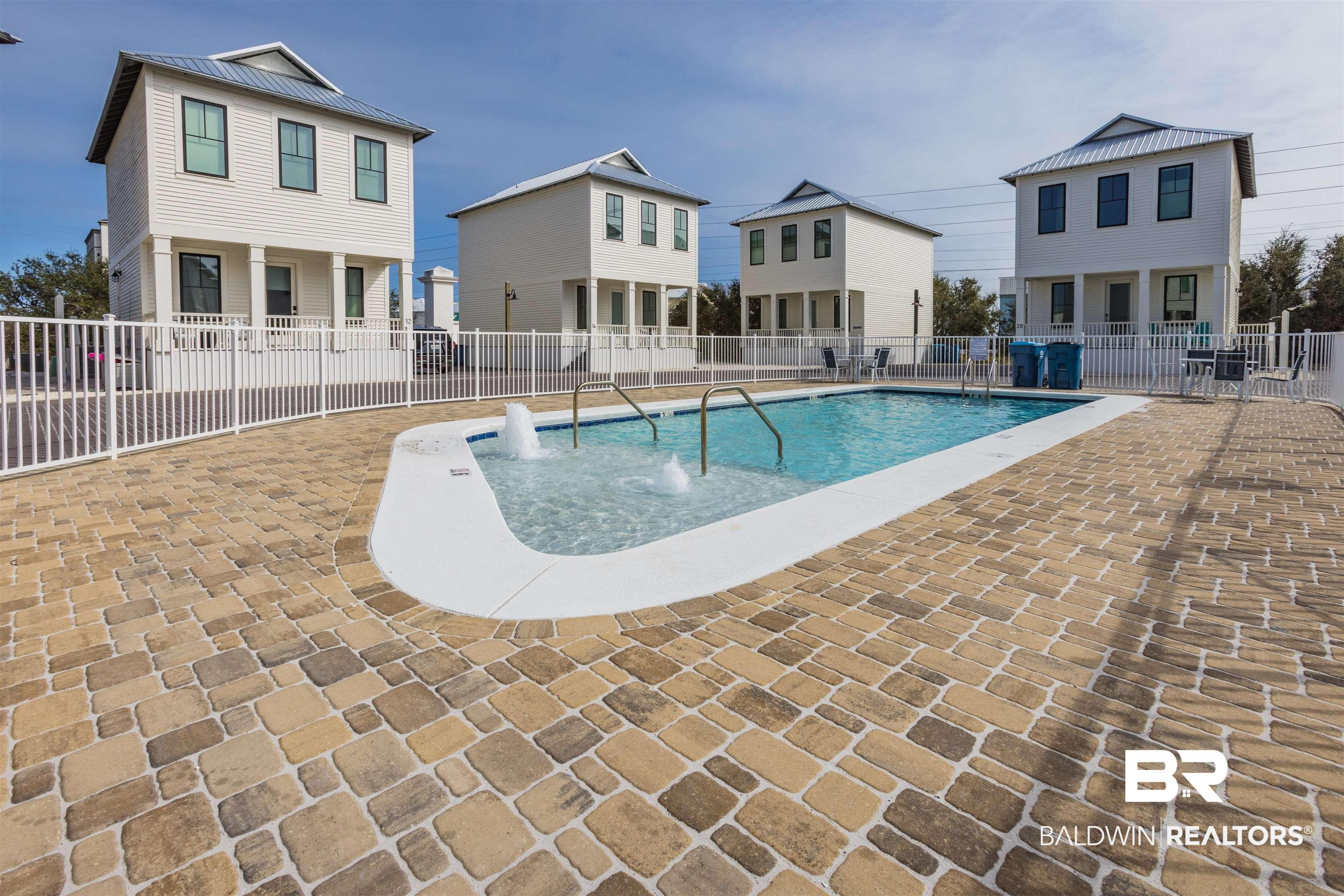 Image 4: Community pool with a patio