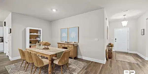 Image 4: Open-concept dining area featuring wood-finish flooring, recessed lighting, and a white baseboard trim