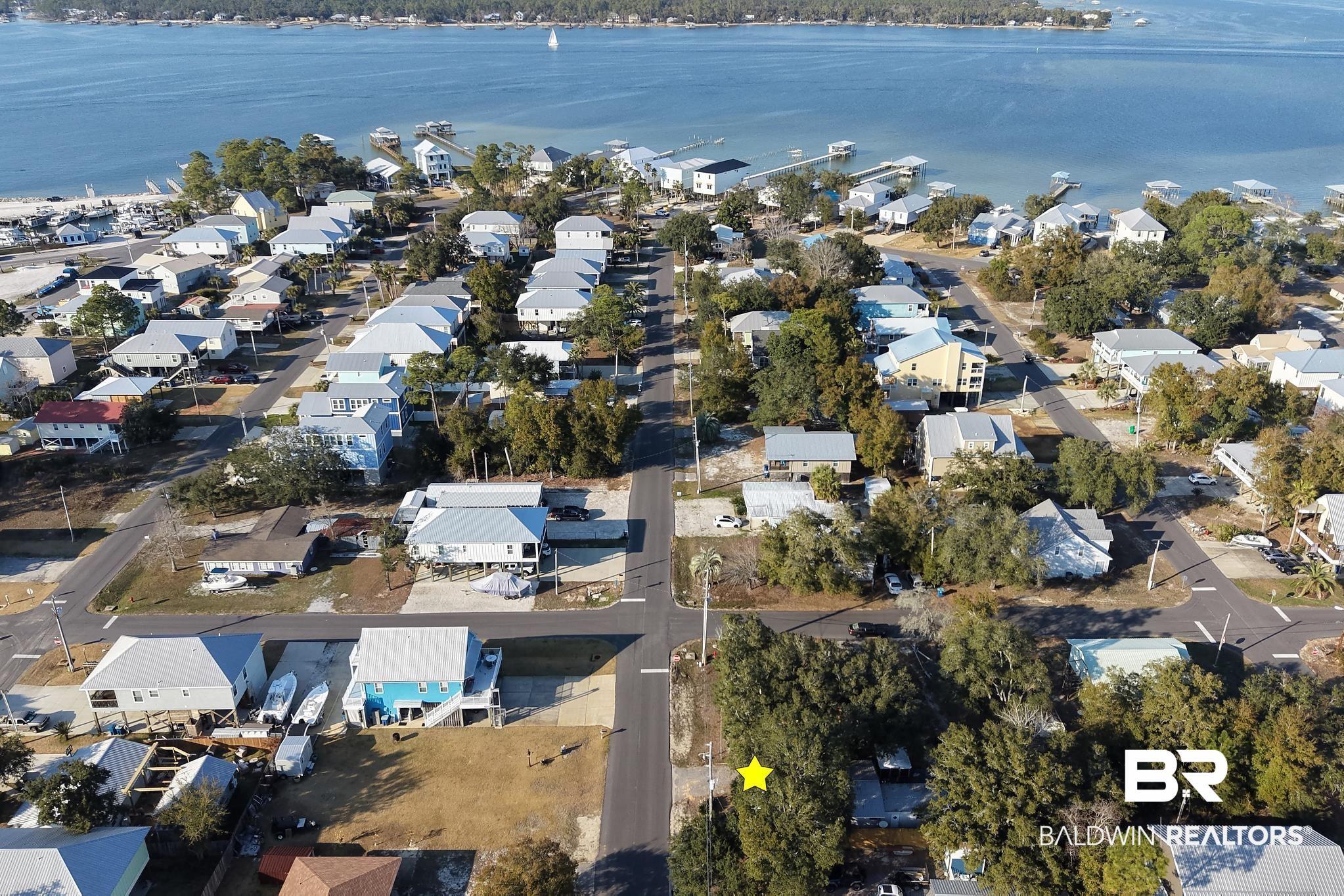 Image 2: Aerial view of property's location featuring nearby suburban area and a large body of water