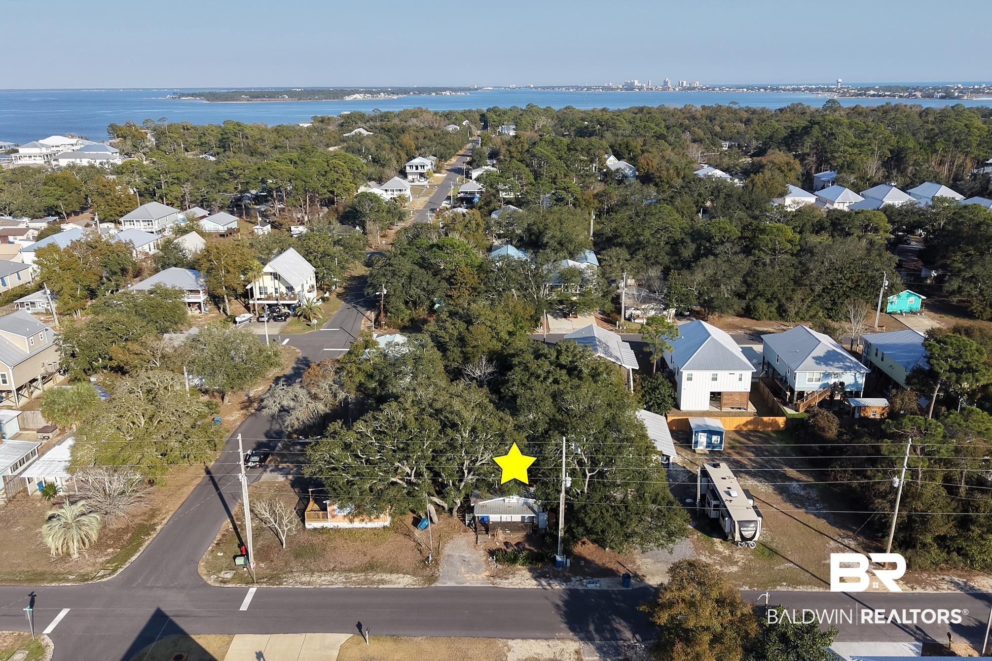 Image 4: Aerial perspective of suburban area featuring a nearby body of water